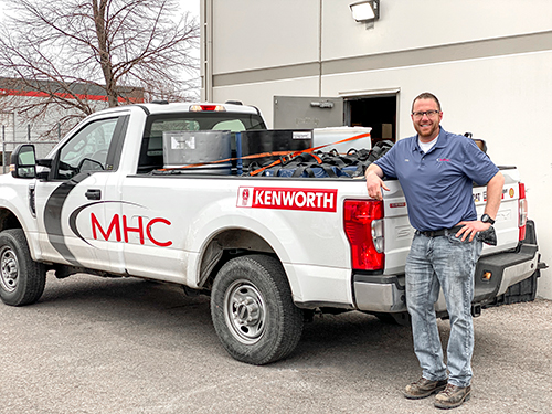 MHC Employee Fritz Nordmann Stands with his Ford F250 Truck After Winning Driver of the Year